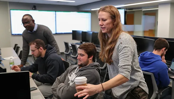 students and instructions work in the finance lab