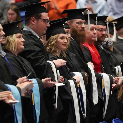 students at commencement wearing graduation robes